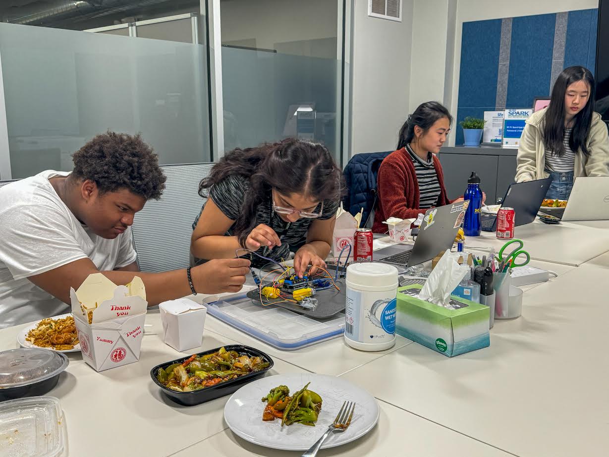 Jacob, Suhani, Alice, and Amy working at SPARK