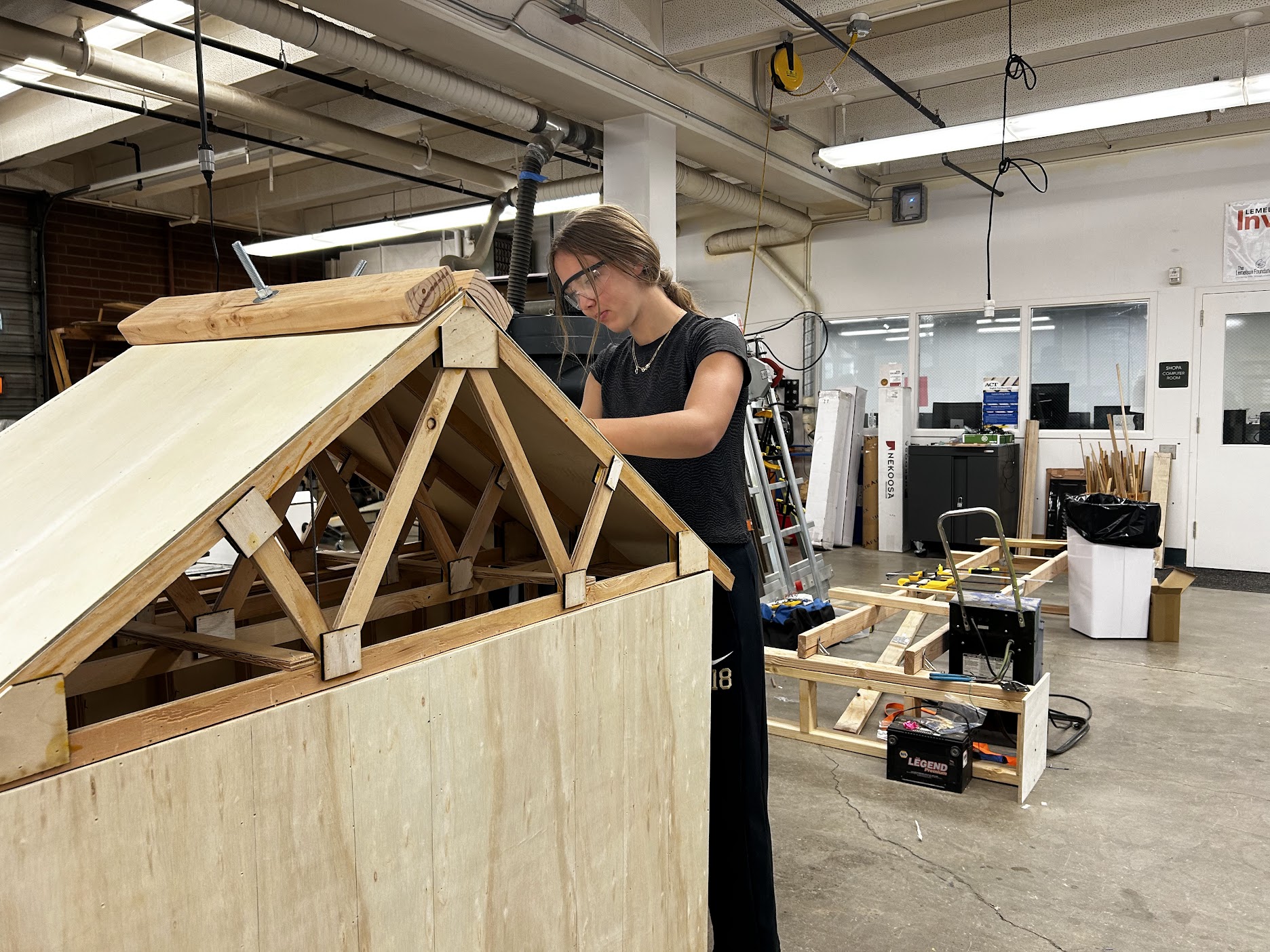 An Incline Village LMIT Team Member painting our demonstration model, which is made out of wood. 