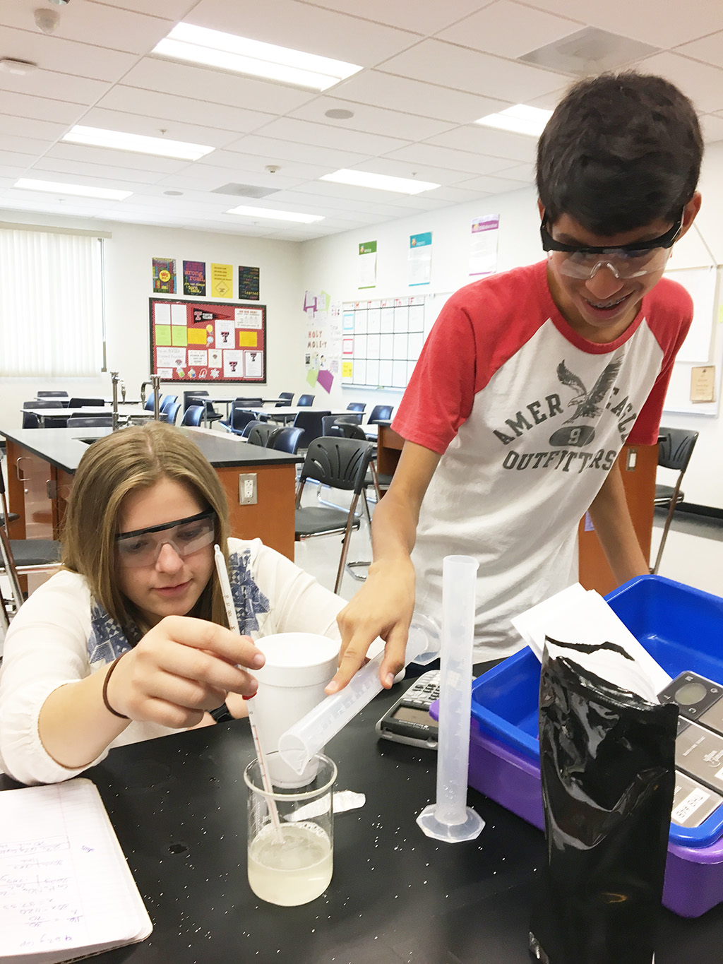 Middle School Girl and Boy student working on an experiment with text that reads: Sign up today!