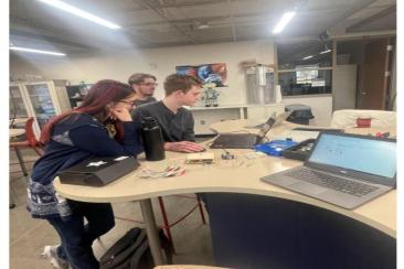 Travis, Heather, and Caleb H working on the load cell.