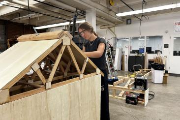 An Incline Village LMIT Team Member painting our demonstration model, which is made out of wood. 